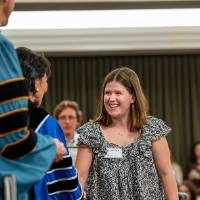 president shaking student hand